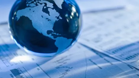 Globe with finacial papers