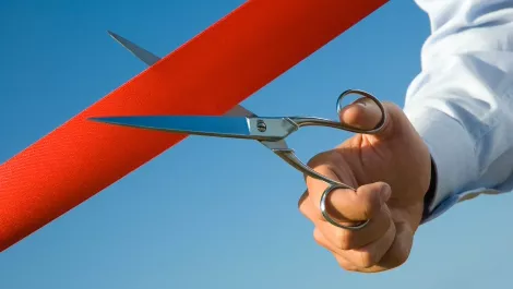 Cutting red ribbon